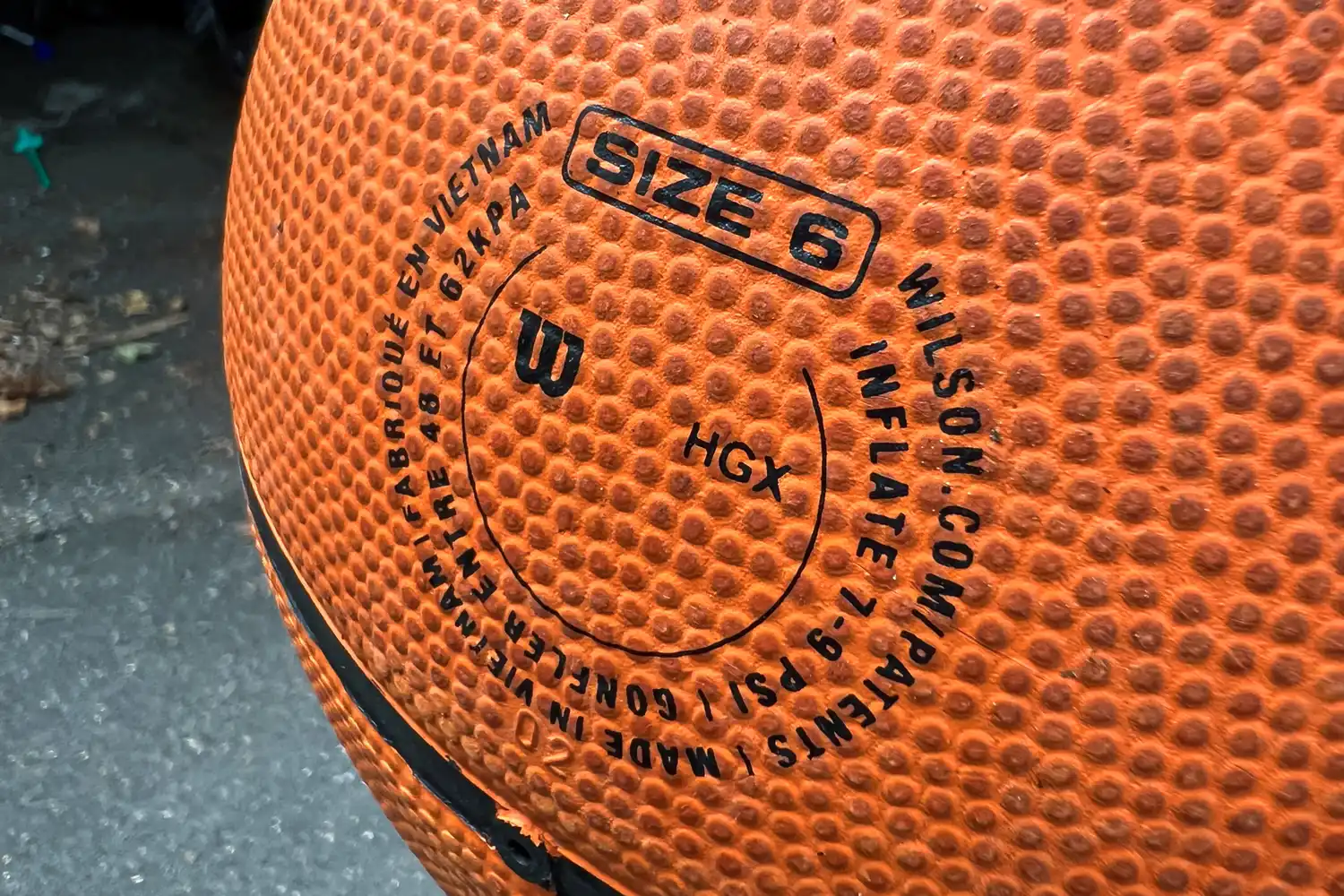 A close-up of the information printed on the Wilson NBA Authentic Outdoor Basketball