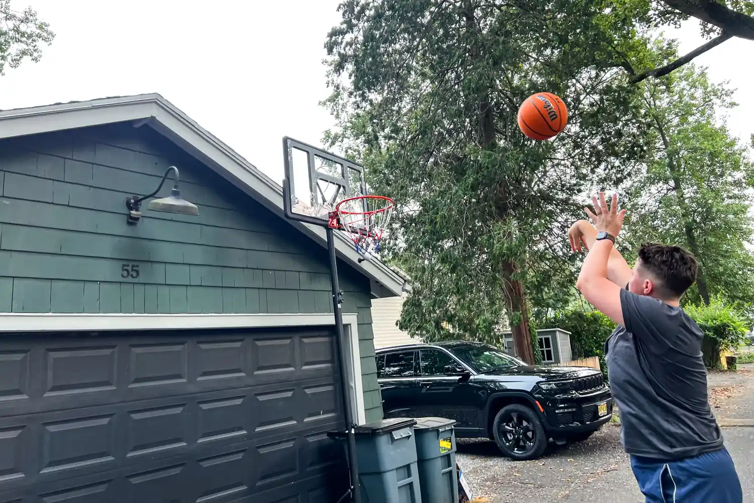 A person shoots the Wilson NBA Authentic Outdoor Basketball