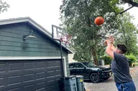 A person shoots the Wilson NBA Authentic Outdoor Basketball