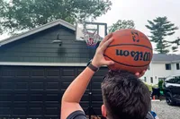 A person shoots the Wilson NBA Authentic Outdoor Basketball