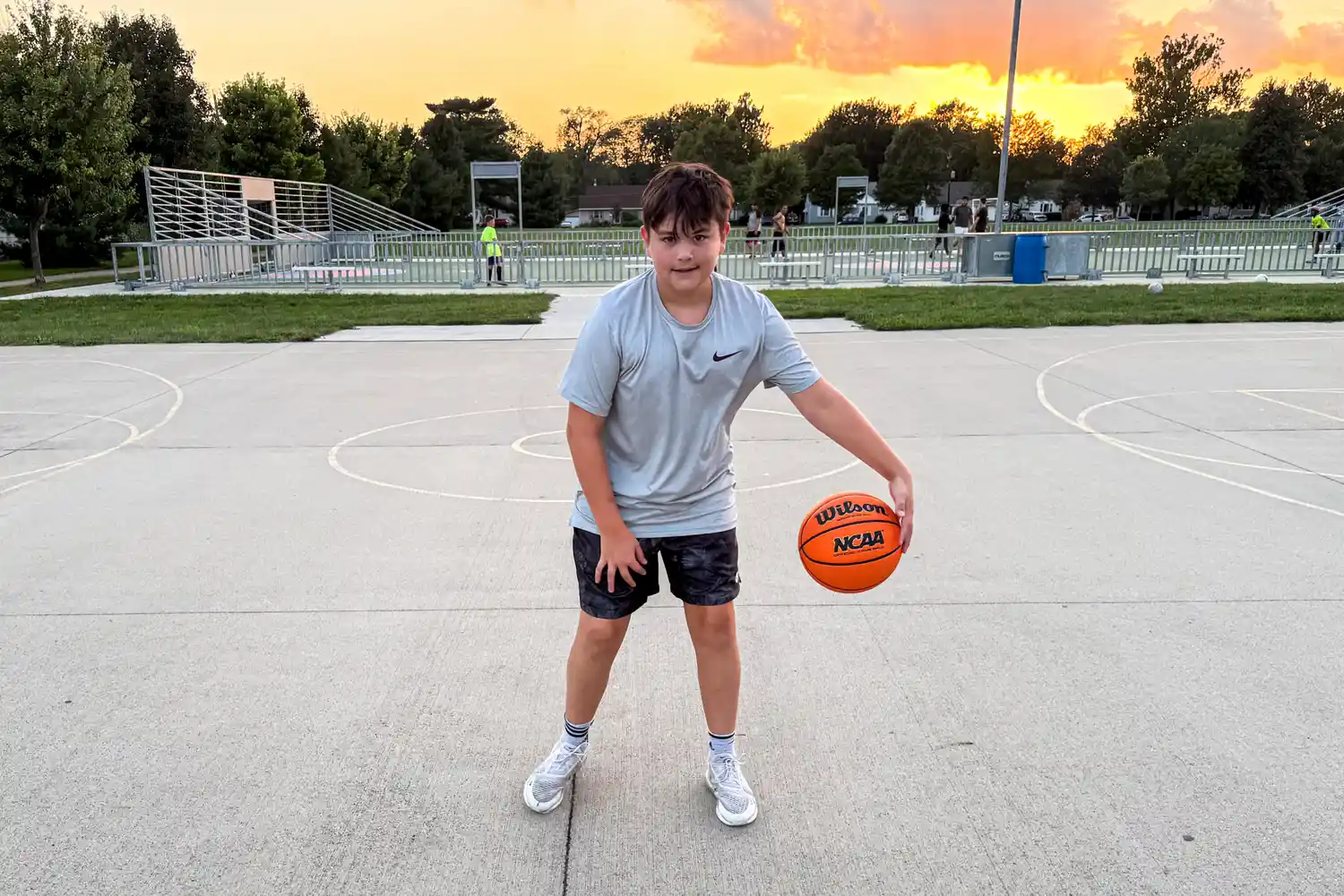 A person dribbles the Wilson NCAA Evo NXT Game Basketball