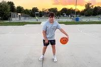 A person dribbles the Wilson NCAA Evo NXT Game Basketball