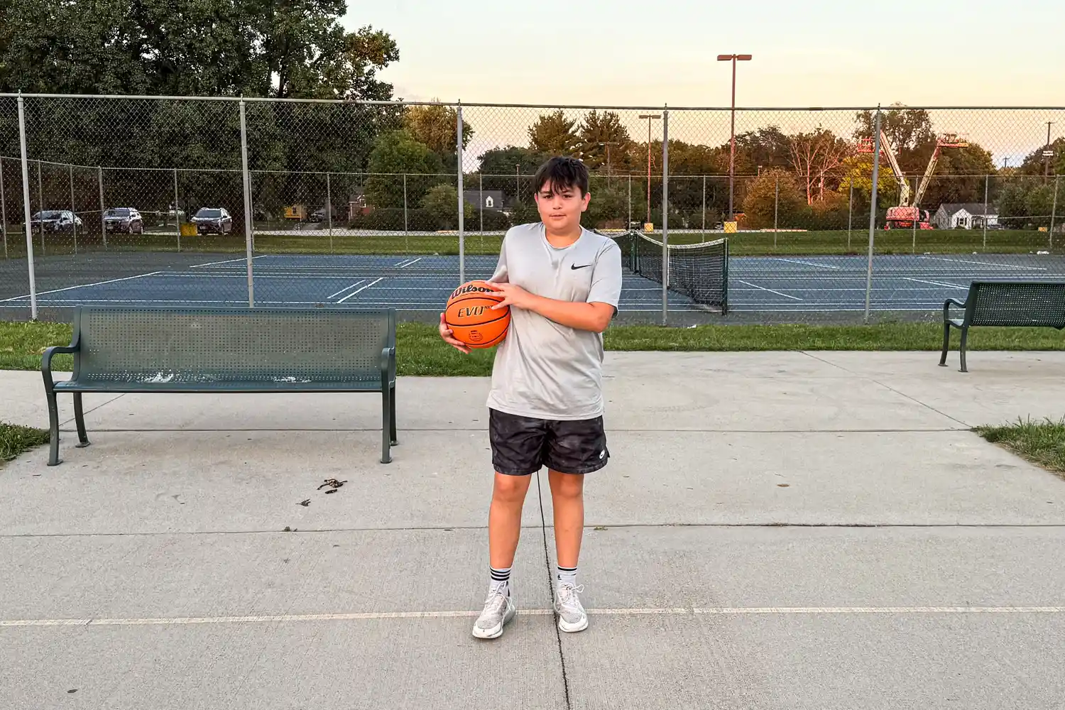 A person holds the Wilson NCAA Evo NXT Game Basketball