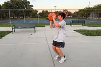 A person shoots the Wilson NCAA Evo NXT Game Basketball