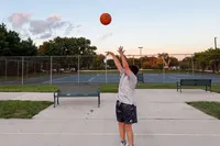 A person shoots the Wilson NCAA Evo NXT Game Basketball