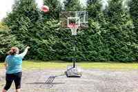 A person shoots the Wilson WNBA Authentic Outdoor Basketball