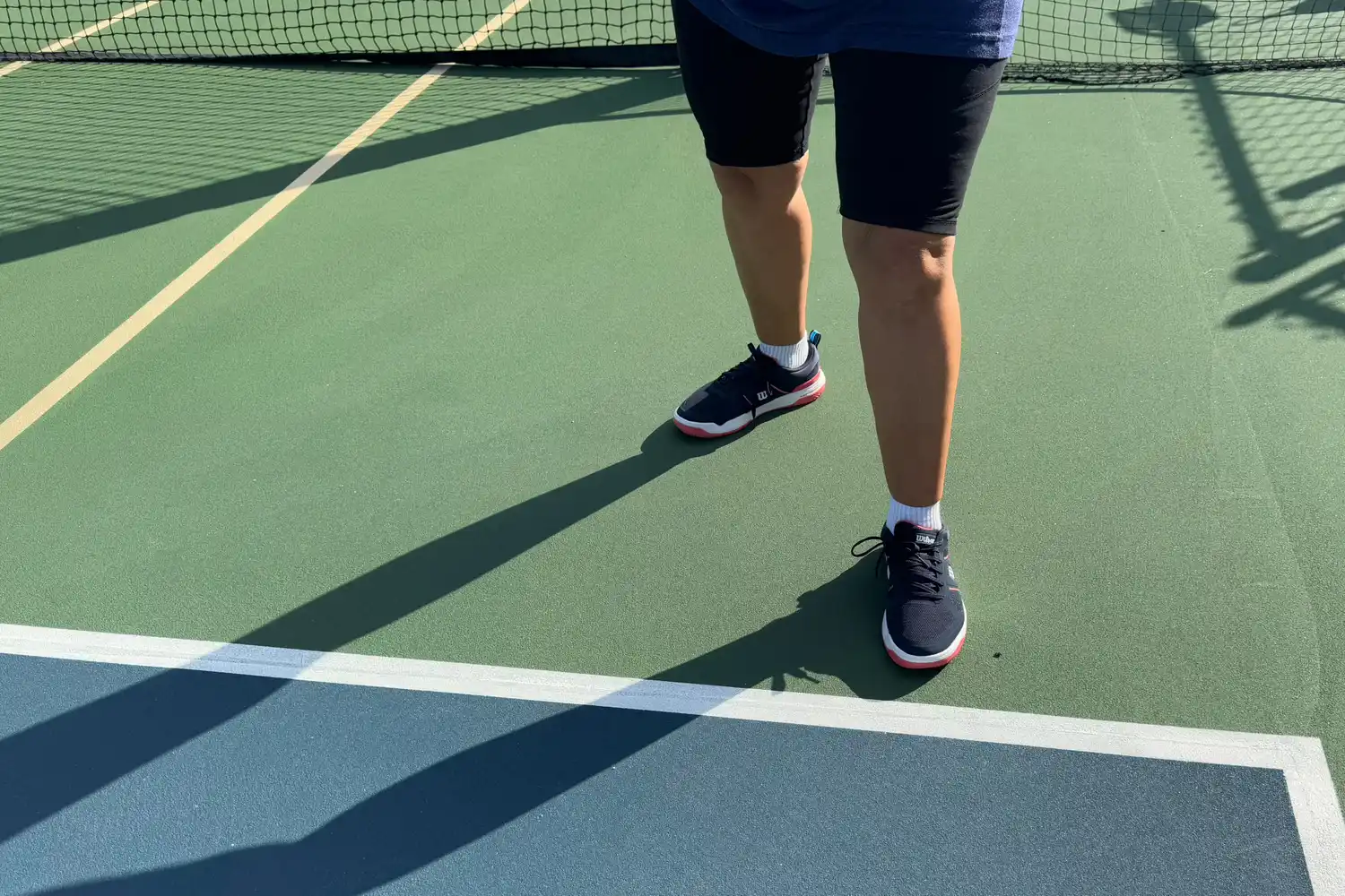 A person wears the Wilson Women's Pickle Pro Pickleball Shoes while playing pickleball