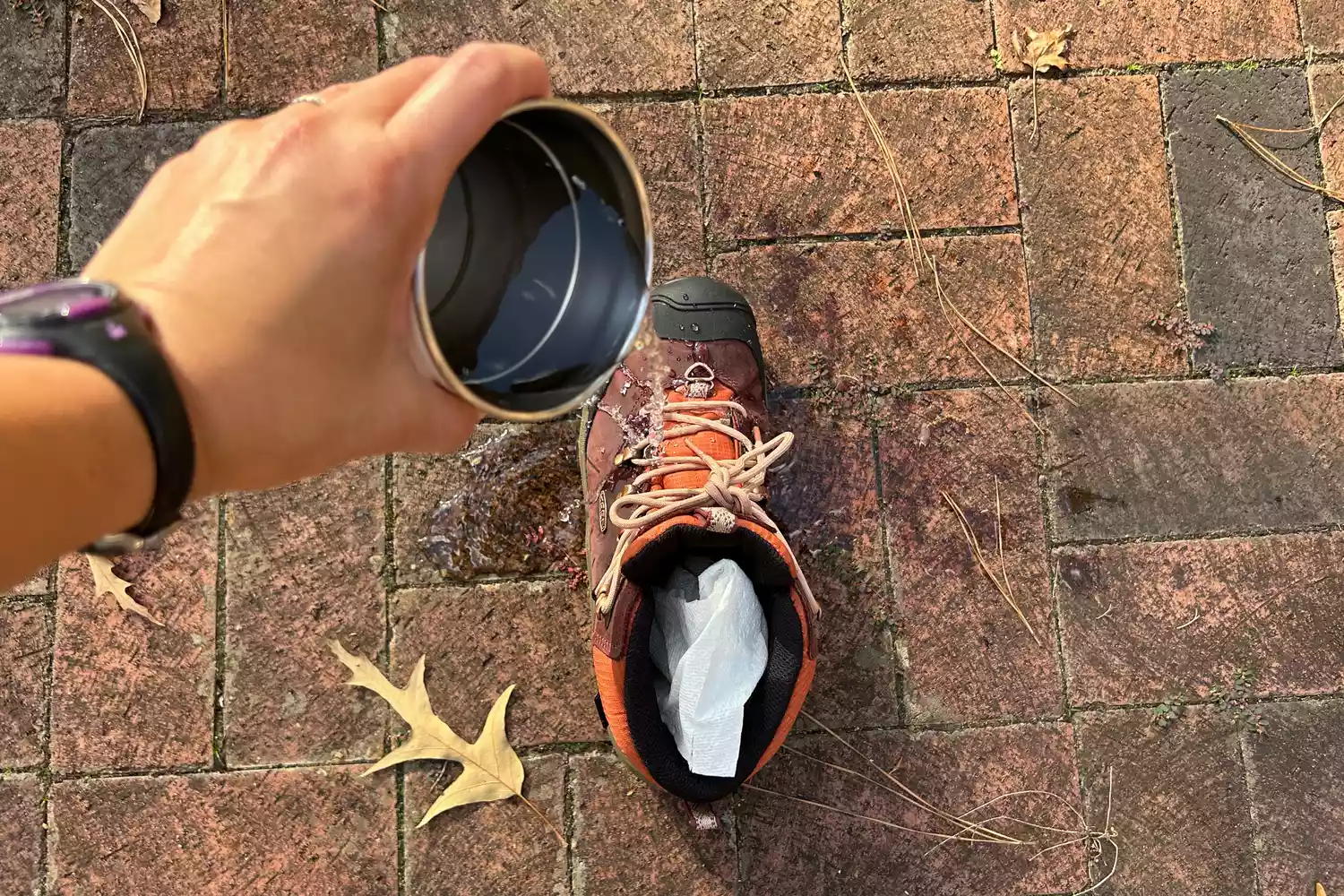 A person pours water onto the Keen Womenâs Revel IV Polar Boot