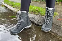 A person wears the Oboz Ousel Mid Insulated Waterproof Boots
