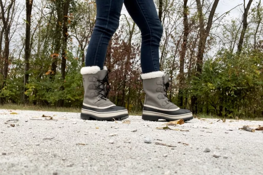 A person wears the Sorel Women's Caribou Waterproof Boots