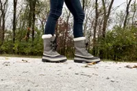 A person wears the Sorel Women's Caribou Waterproof Boots