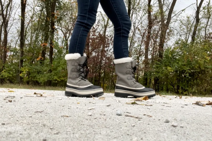 A person wears the Sorel Women's Caribou Waterproof Boots