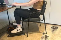 A side view of a person using the YOSUDA E5 Under Desk Elliptical Machine