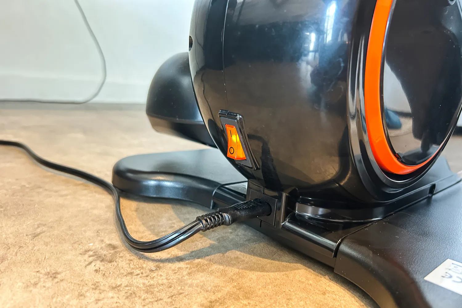 The adapter cord and on/off switch on the YOSUDA E5 Under Desk Elliptical Machine