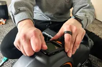 A person adjusts the YOSUDA YBM-2 Under Desk Bike Pedal Exerciser