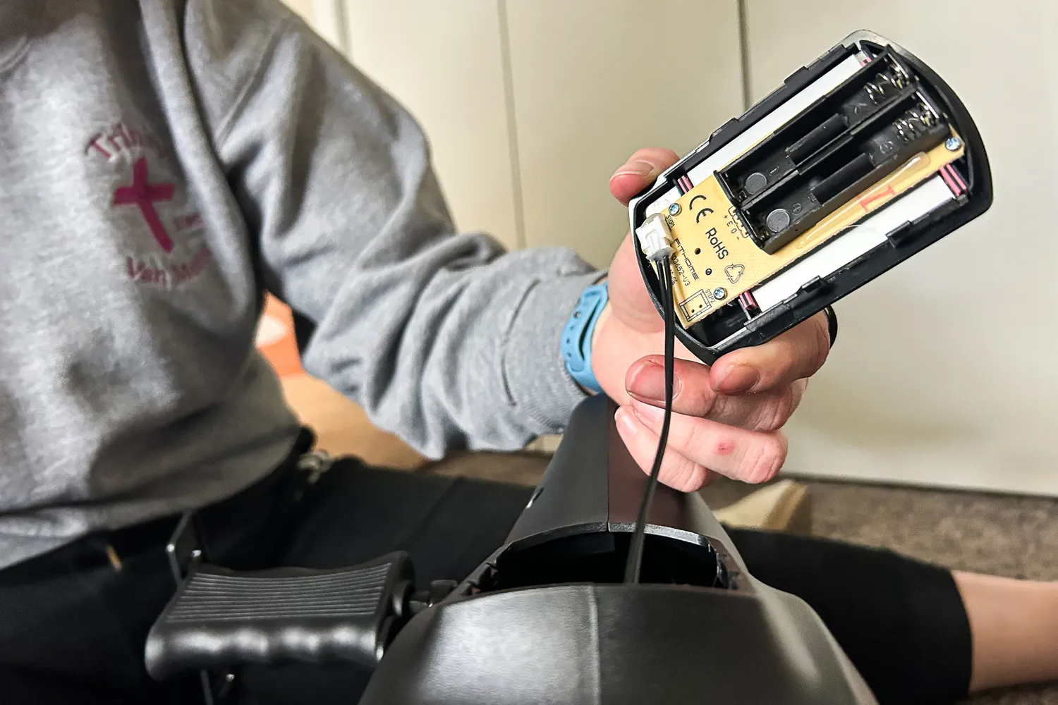 A person assembles the YOSUDA YBM-2 Under Desk Bike Pedal Exerciser