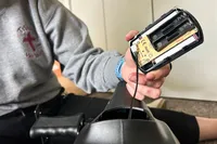 A person assembles the YOSUDA YBM-2 Under Desk Bike Pedal Exerciser