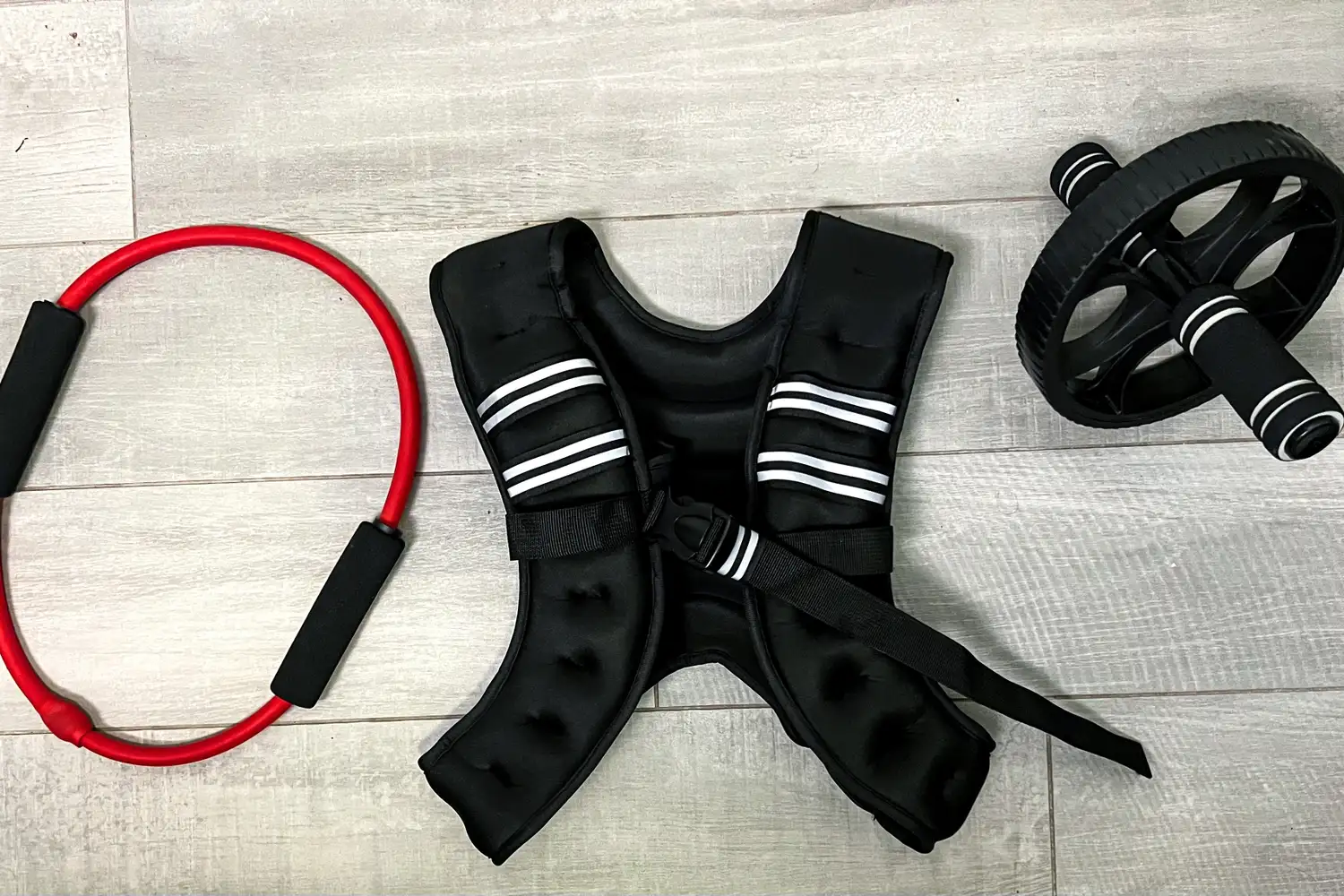 The Zelus Weighted Vest on the ground next to a pilates ring