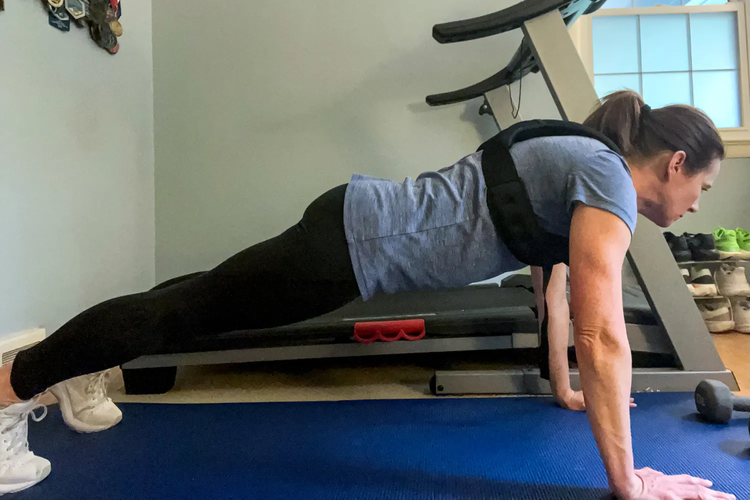 A person does pushups while wearing the Zelus Weighted Vest