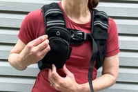 A person unzips a pocket on the Zelus Weighted Vest