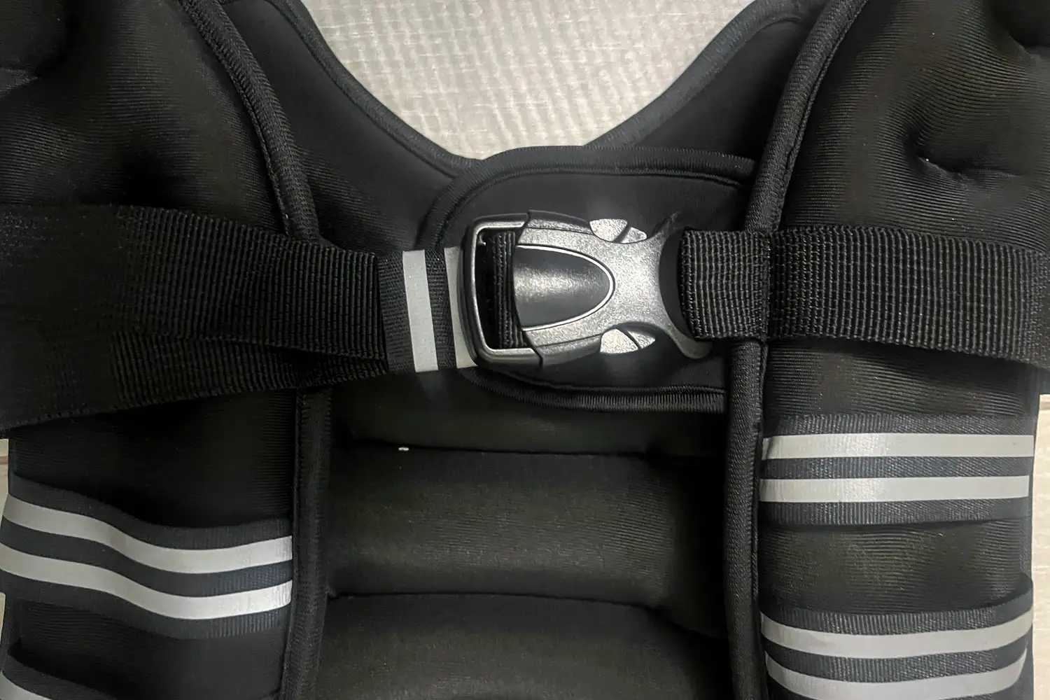 The buckle on the front of the Zelus Weighted Vest