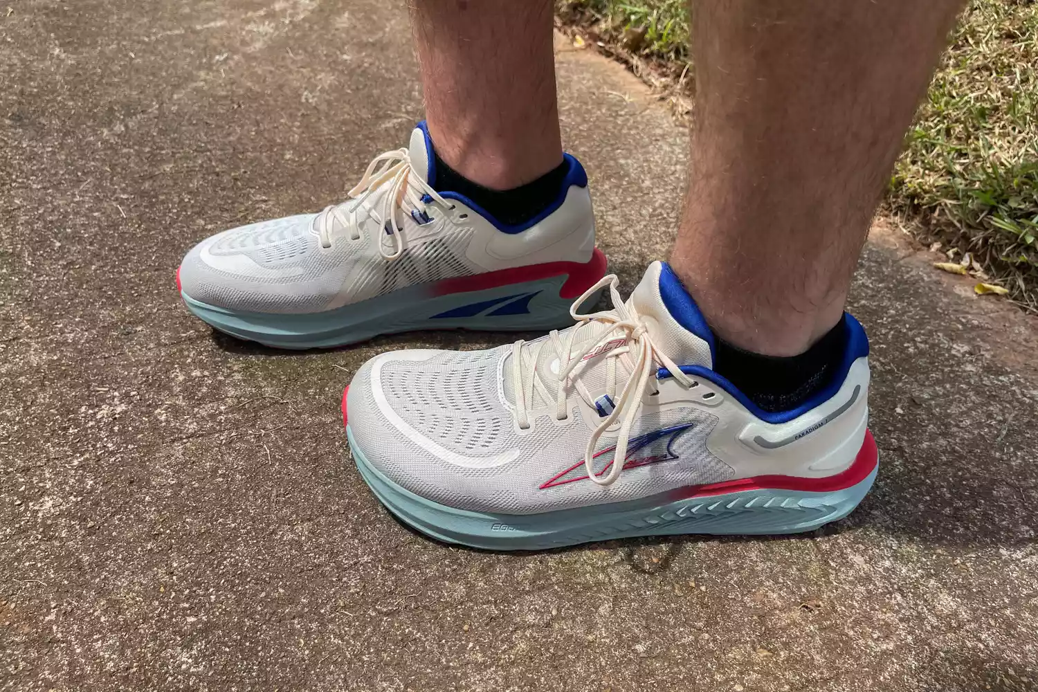 A close-up of two legs outdoors while wearing Altra Paradigm 7 sneakers