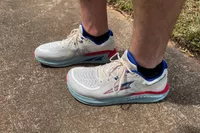 A close-up of two legs outdoors while wearing Altra Paradigm 7 sneakers