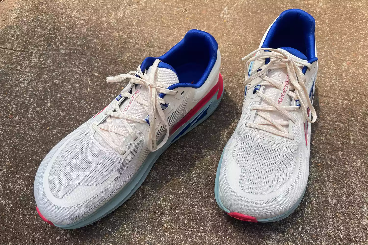 Two Altra Paradigm 7 sneakers posed on concrete