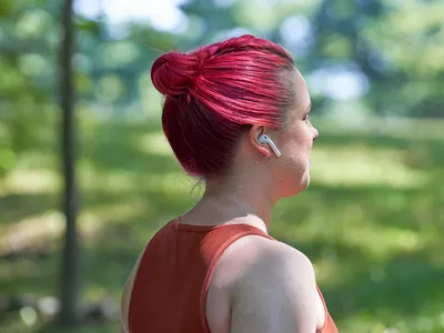 Woman walking and listening to music