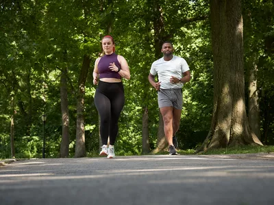 Man and woman running outside