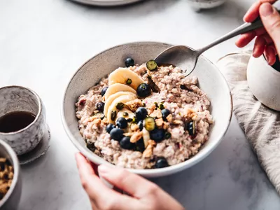 Woman making healthy breakfast in kitchen