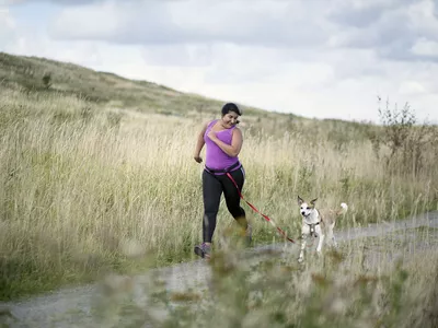 Woman running with dog