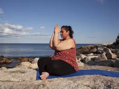 Woman meditating with hands to the third eye